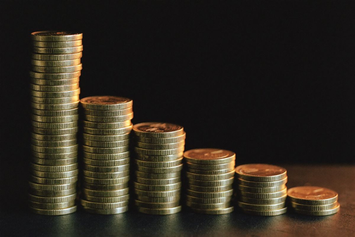 Stacks of gold coins in warm light