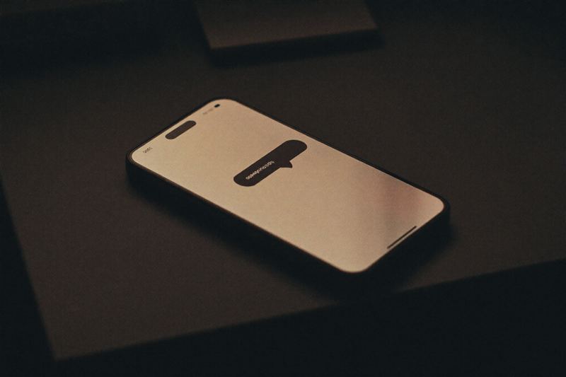 Smartphone showing a chat bubble in warm light